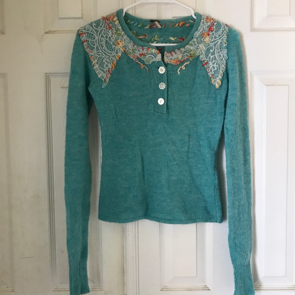 Free People light teal embroidered sweater.